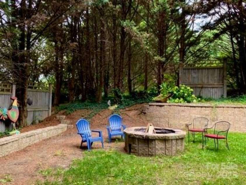 142 Justice Street, Fletcher, NC 28732.  MLS# CAR4234693, YatesRealty ID 19634. Relax and entertain by the firepit in the backyard