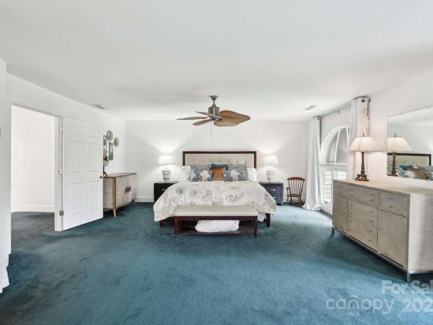 142 Justice Street, Fletcher, NC 28732.  MLS# CAR4234693, YatesRealty ID 19634. Spacious primary suite provides seclusion and flexible living possibilities