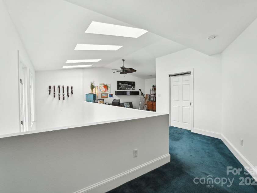 142 Justice Street, Fletcher, NC 28732.  MLS# CAR4234693, YatesRealty ID 19634. The home’s flexible layout includes dual primary bedrooms upstairs, perfect for comfort and privacy