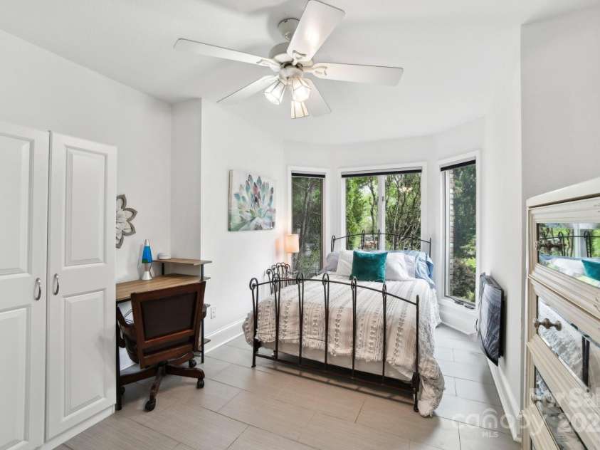 142 Justice Street, Fletcher, NC 28732.  MLS# CAR4234693, YatesRealty ID 19634. This sun-drenched bedroom offers both comfort and charm