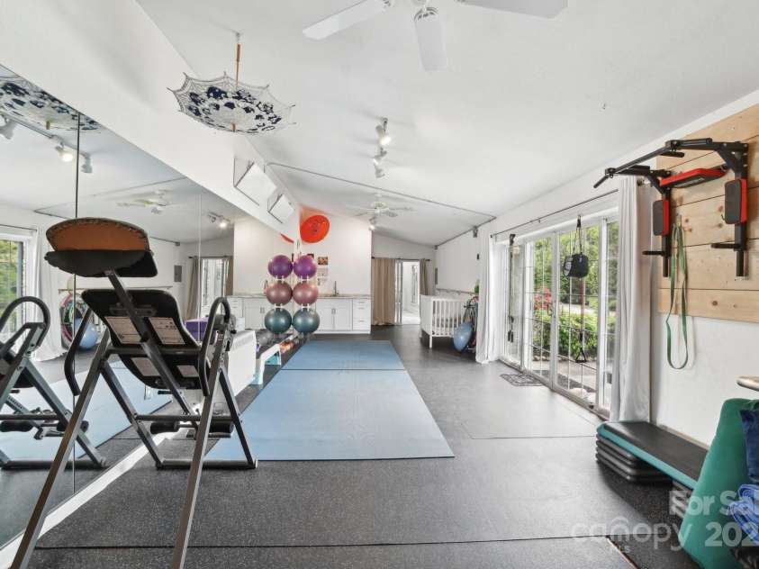 142 Justice Street, Fletcher, NC 28732.  MLS# CAR4234693, YatesRealty ID 19634. Versatile studio/workshop with its own entrance—ideal for guests, a home office, or creative space