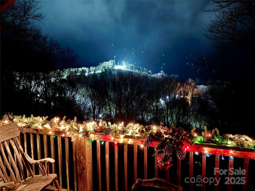 2399 El Miner Drive, Mars Hill, NC 28754.  MLS# CAR4259953, YatesRealty ID 19670. A cozy winter night on the deck, aglow with festive lights and framed by the sparkling slopes of Hatley Pointe Ski Resort just beyond.