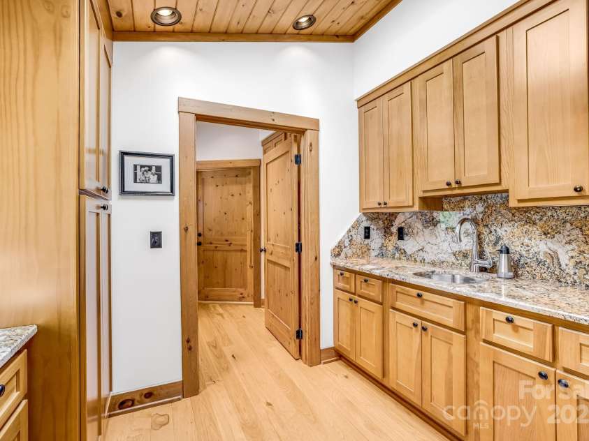 2399 El Miner Drive, Mars Hill, NC 28754.  MLS# CAR4259953, YatesRealty ID 19670. A dedicated prep kitchen with a sink, storage for pantry essentials and dishes, plus ample space for a sous chef to assist with culinary creations.
