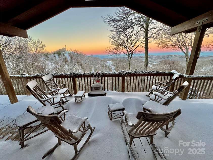 2399 El Miner Drive, Mars Hill, NC 28754.  MLS# CAR4259953, YatesRealty ID 19670. A snowy morning sanctuary—rocking chairs dusted in fresh powder, sunrise painting the sky, and ski slopes in the distance. Winter serenity at its finest. #PorchViews