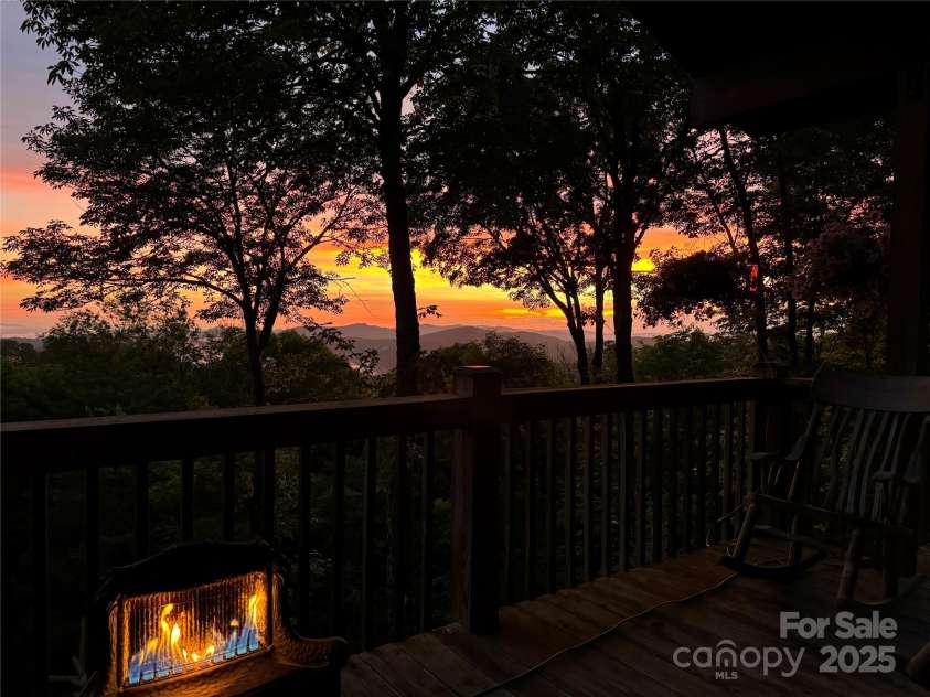 2399 El Miner Drive, Mars Hill, NC 28754.  MLS# CAR4259953, YatesRealty ID 19670. Evening serenity on the porch at 2399 El Miner — where the forest glows and the mountains whisper. #SunsetSanctuary #MountainRetreat #WesternNCViews