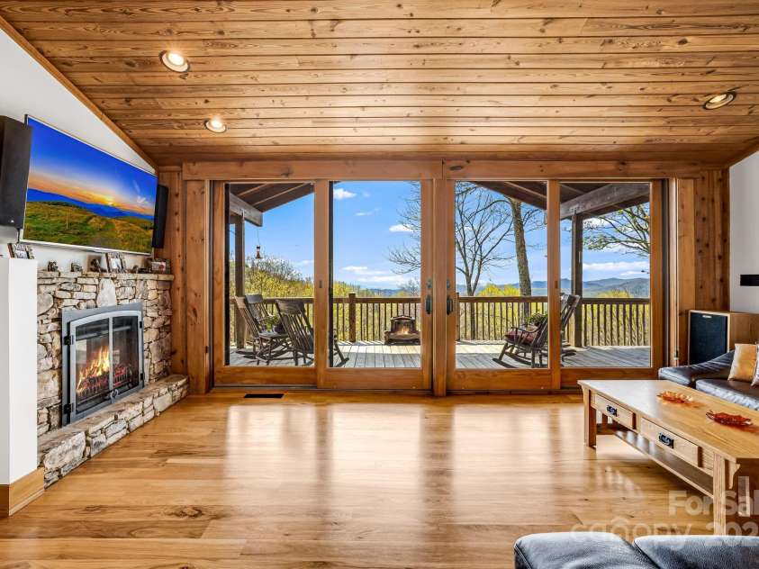 2399 El Miner Drive, Mars Hill, NC 28754.  MLS# CAR4259953, YatesRealty ID 19670. The 8ft double sliding glass doors frame a living canvas, capturing nature's ever-changing masterpiece in every season.