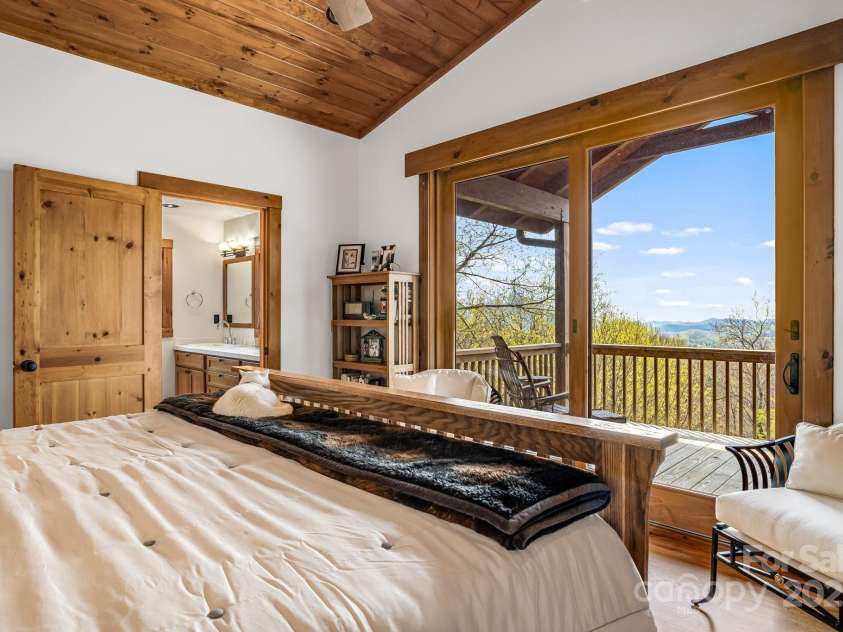 2399 El Miner Drive, Mars Hill, NC 28754.  MLS# CAR4259953, YatesRealty ID 19670. The space is bathed in natural light from the large glass doors, which open to breathtaking mountain views and a private deck, creating a seamless connection to the surrounding landscape.