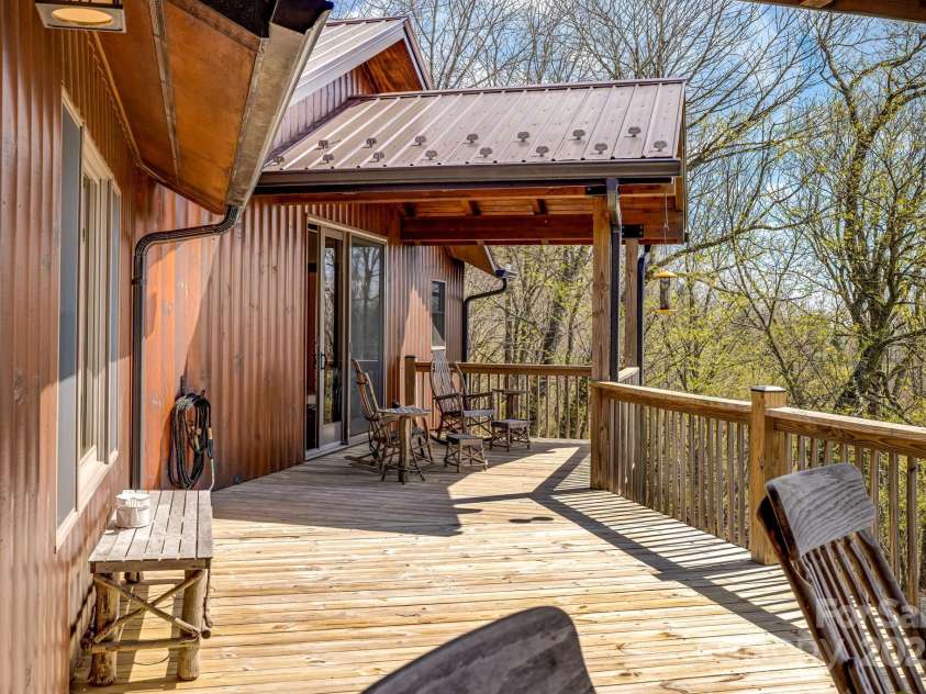 2399 El Miner Drive, Mars Hill, NC 28754.  MLS# CAR4259953, YatesRealty ID 19670. The upper primary bedroom opens to a private deck, perfect for morning coffee or evening stargazing. Enjoy sweeping mountain views and fresh mountain breezes from this elevated perch.