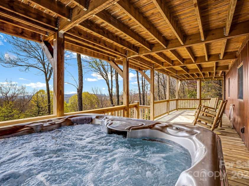 2399 El Miner Drive, Mars Hill, NC 28754.  MLS# CAR4259953, YatesRealty ID 19670. This expansive lower deck offers plenty of space for rocking chairs and outdoor seating, perfect for enjoying the fresh mountain air.