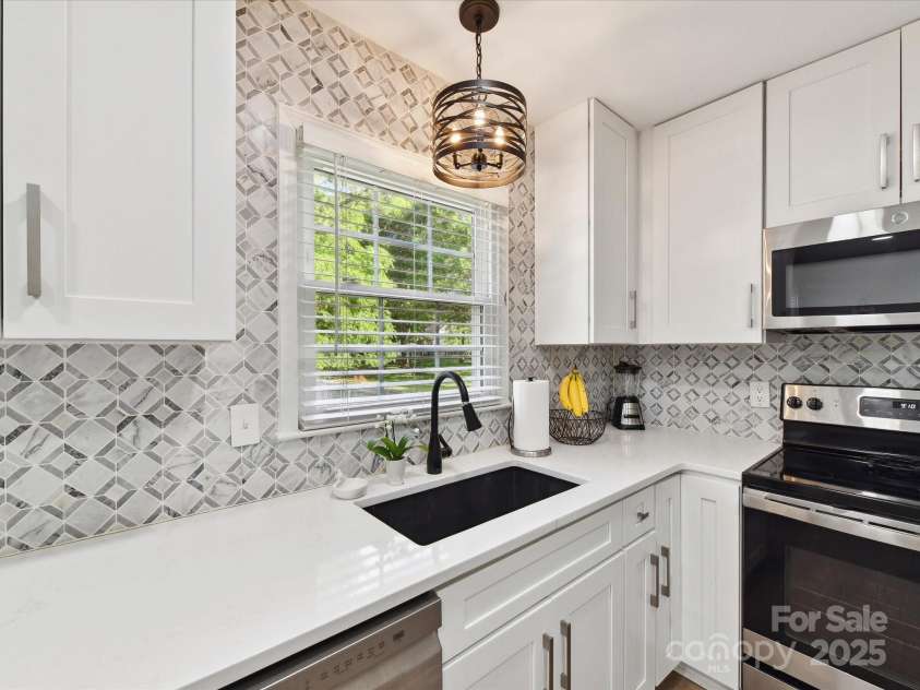 2315 Lawton Bluff Road, Charlotte, NC 28226.  MLS# CAR4255535, YatesRealty ID 19671. Lovely view out of the kitchen to the large backyard!