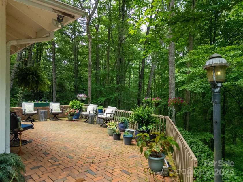 168 River Ridge Road, Brevard, NC 28712.  MLS# CAR4260361, YatesRealty ID 19694. Lovely patio overlooking forest