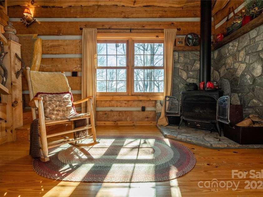 1074 Indian Camp Mountain Road, Rosman, NC 28772.  MLS# CAR4109820, YatesRealty ID 1970. Guest cabin wood stove