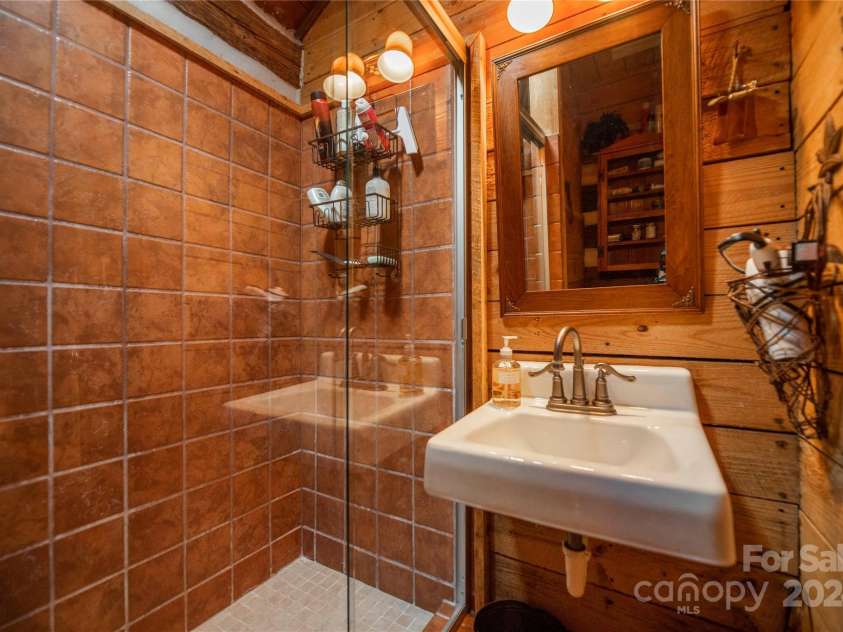 1074 Indian Camp Mountain Road, Rosman, NC 28772.  MLS# CAR4109820, YatesRealty ID 1970. Main cabin guest bathroom