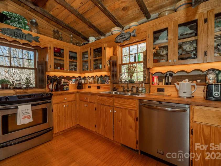 1074 Indian Camp Mountain Road, Rosman, NC 28772.  MLS# CAR4109820, YatesRealty ID 1970. Main cabin kitchen