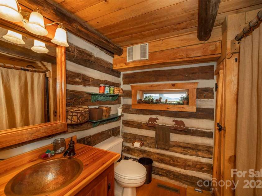 1074 Indian Camp Mountain Road, Rosman, NC 28772.  MLS# CAR4109820, YatesRealty ID 1970. Main cabin, main floor bathroom