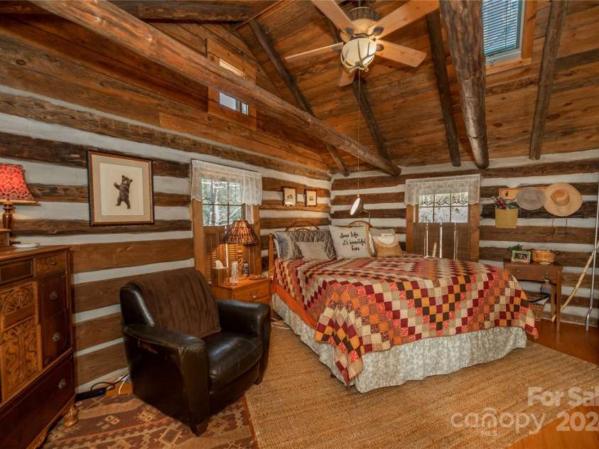 1074 Indian Camp Mountain Road, Rosman, NC 28772.  MLS# CAR4109820, YatesRealty ID 1970. Main cabin primary bedroom