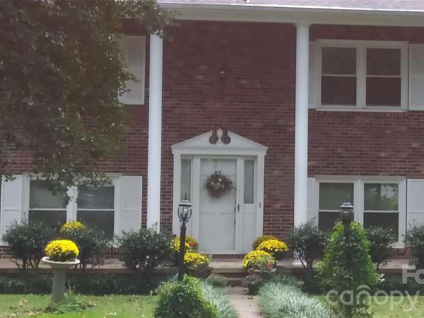 3065 Woodstream Drive, Valdese, NC 28690.  MLS# CAR4295069, YatesRealty ID 19704. Fall flowers make all the difference.