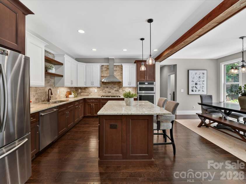 205 Streamwood Road, Troutman, NC 28166.  MLS# CAR4378738, YatesRealty ID 19708. Thoughtfully designed gourmet kitchen offers expansive prep space, granite counters, stainless steel appliances, custom cabinetry, designer lighting, a gas cooktop with stainless hood, and seamless flow into the dining 
