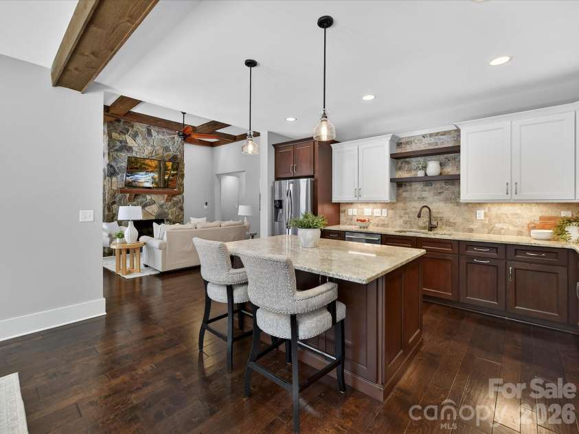 205 Streamwood Road, Troutman, NC 28166.  MLS# CAR4378738, YatesRealty ID 19708. Thoughtfully designed gourmet kitchen offers expansive prep space, granite counters, stainless steel appliances, custom cabinetry, designer lighting, a gas cooktop with stainless hood, and seamless flow into the dining 
