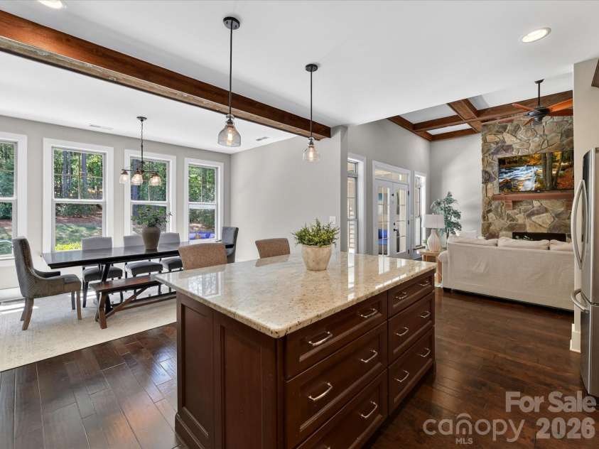 205 Streamwood Road, Troutman, NC 28166.  MLS# CAR4378738, YatesRealty ID 19708. Thoughtfully designed gourmet kitchen offers expansive prep space, granite counters, stainless steel appliances, custom cabinetry, designer lighting, a gas cooktop with stainless hood, and seamless flow into the dining 