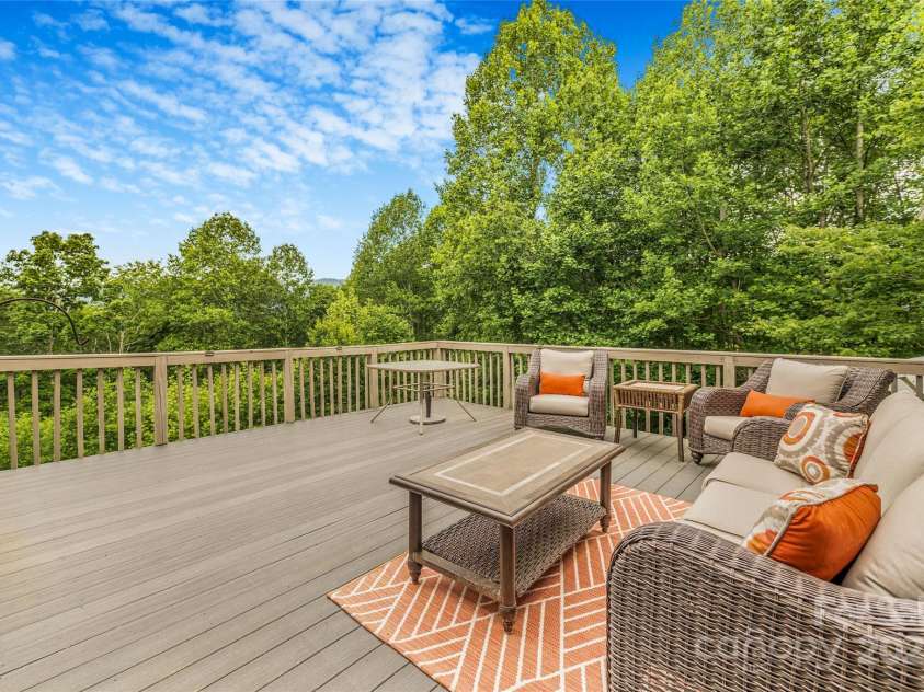 121 Ashe Bridge Road, Marion, NC 28752.  MLS# CAR4256500, YatesRealty ID 19710. Back deck with sunset views, mountain views and a lovely tree canopy for the birds.