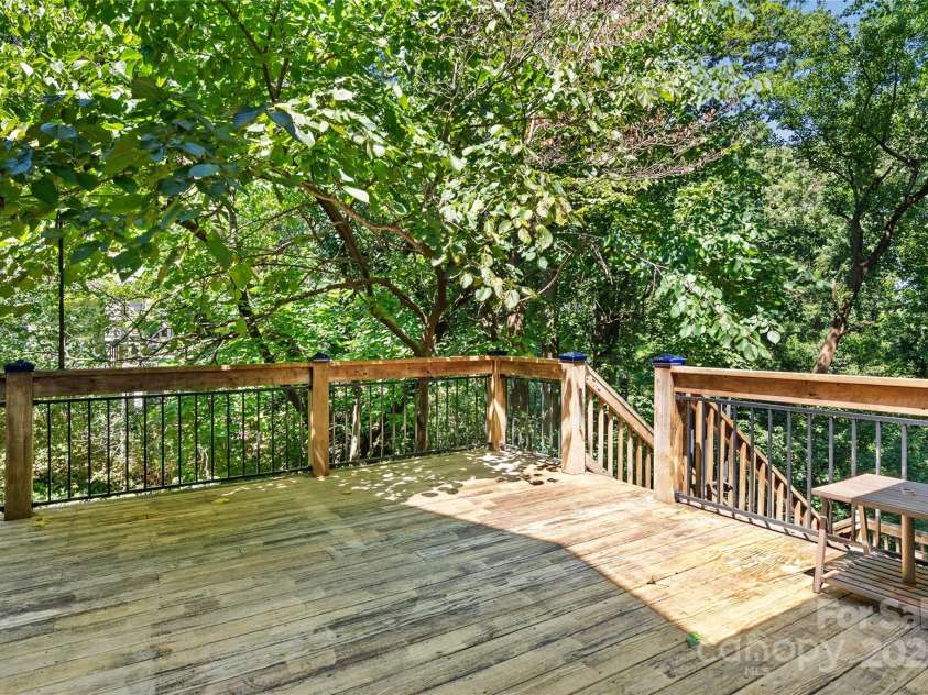 80 Laurel Avenue, Tryon, NC 28782.  MLS# CAR4299418, YatesRealty ID 1972. Back deck leads down to a fenced yard for pets.