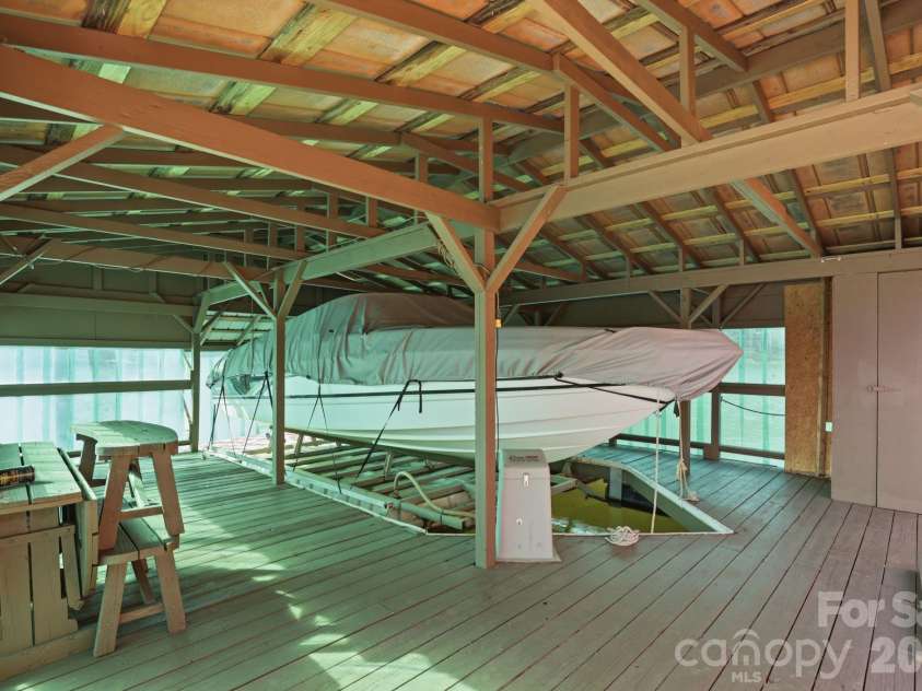 236 Apache Road, Troutman, NC 28166.  MLS# CAR4359171, YatesRealty ID 19726. Boat lift included in covered slip with storage area on dock. 