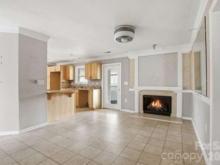 236 Apache Road, Troutman, NC 28166.  MLS# CAR4359171, YatesRealty ID 19726. Den with fireplace.