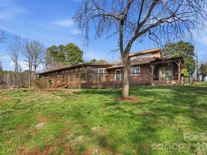 236 Apache Road, Troutman, NC 28166.  MLS# CAR4359171, YatesRealty ID 19726. Level lot, view of home from dock,