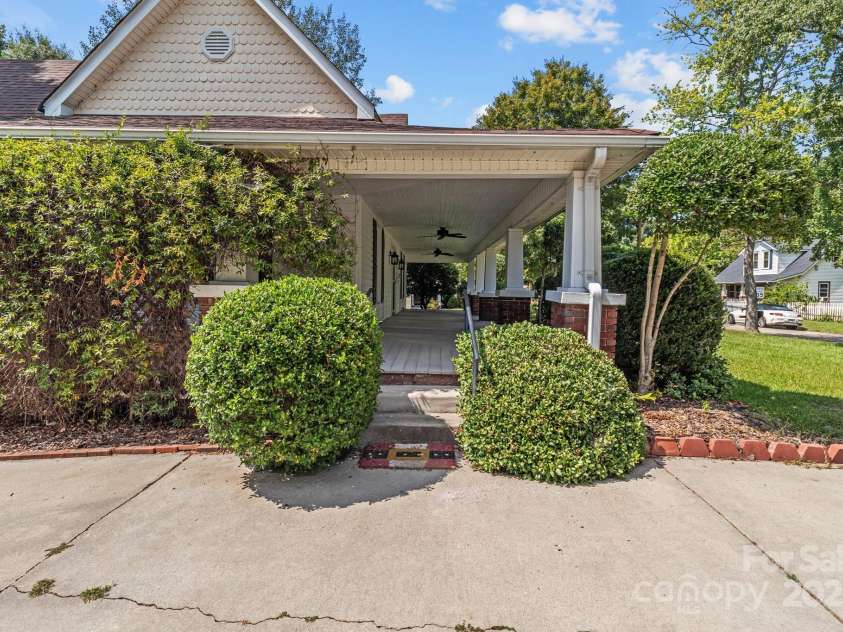 405 7th Street, Spencer, NC 28159.  MLS# CAR4185619, YatesRealty ID 19730. Side porch with composite deck boards