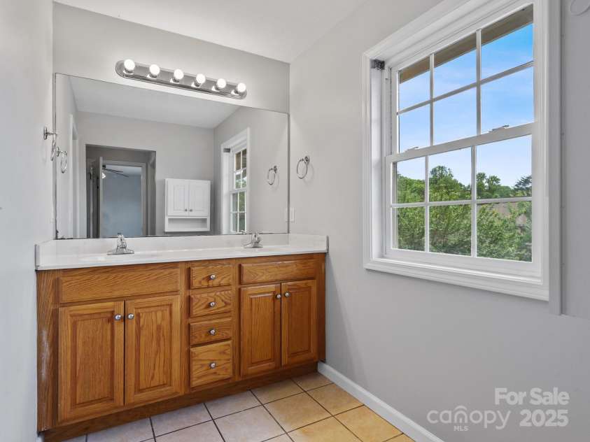 23 Aberdeen Drive, Arden, NC 28704.  MLS# CAR4258815, YatesRealty ID 19735. Double vanity. Primary bathroom.