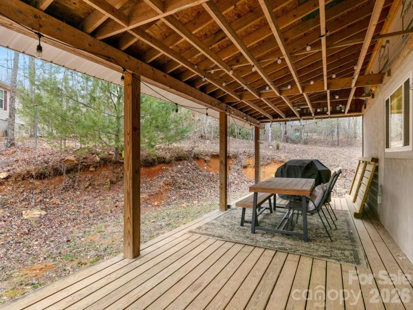 10 Bear Trail, Fairview, NC 28730.  MLS# CAR4232914, YatesRealty ID 19748. Back porch - since pictures were taken, ceiling of back porch has been finished and railings added. 