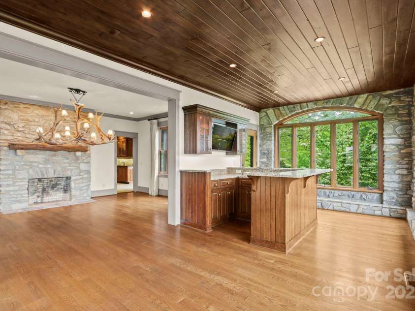 1245 Laurel Lane, Blowing Rock, NC 28605.  MLS# CAR4228582, YatesRealty ID 19780. Bar & Sunroom connected to living and dining....