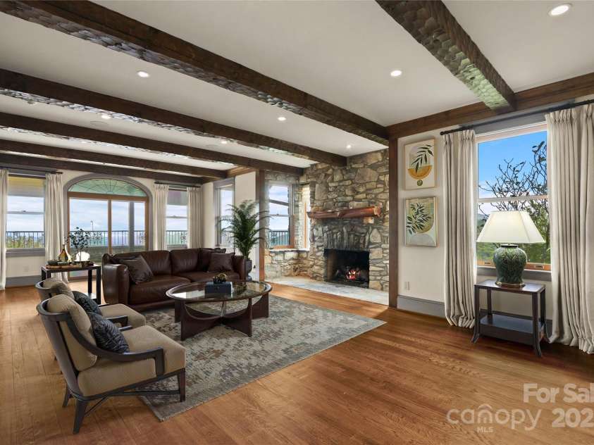1245 Laurel Lane, Blowing Rock, NC 28605.  MLS# CAR4228582, YatesRealty ID 19780. (Virtual Staging). Open living with exposed beams, stone fireplace, gorge views & deck access....
