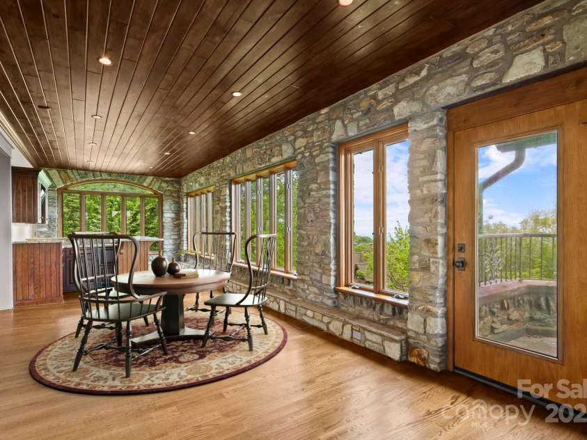 1245 Laurel Lane, Blowing Rock, NC 28605.  MLS# CAR4228582, YatesRealty ID 19780. (Virtual Staging). The living space extends across the back of the home w/ sunroom & wall of windows, bar, VIEWS....