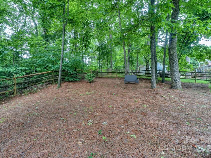 14831 Charterhouse Lane, Huntersville, NC 28078.  MLS# CAR4264707, YatesRealty ID 19794. Backyard natural area would make for a perfect firepit area or shaded playground equipment
