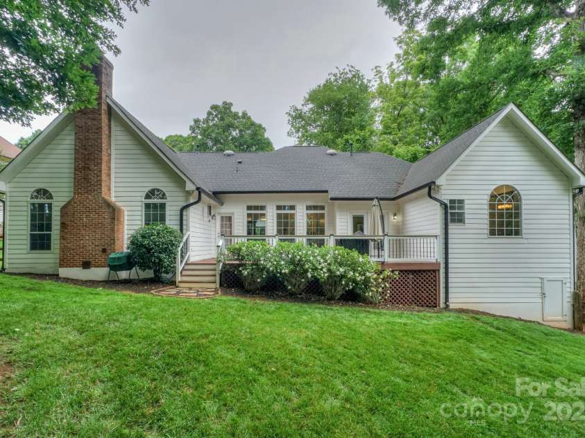 14831 Charterhouse Lane, Huntersville, NC 28078.  MLS# CAR4264707, YatesRealty ID 19794. Beautiful and grassy back yard showing storage under deck and walk in crawl space