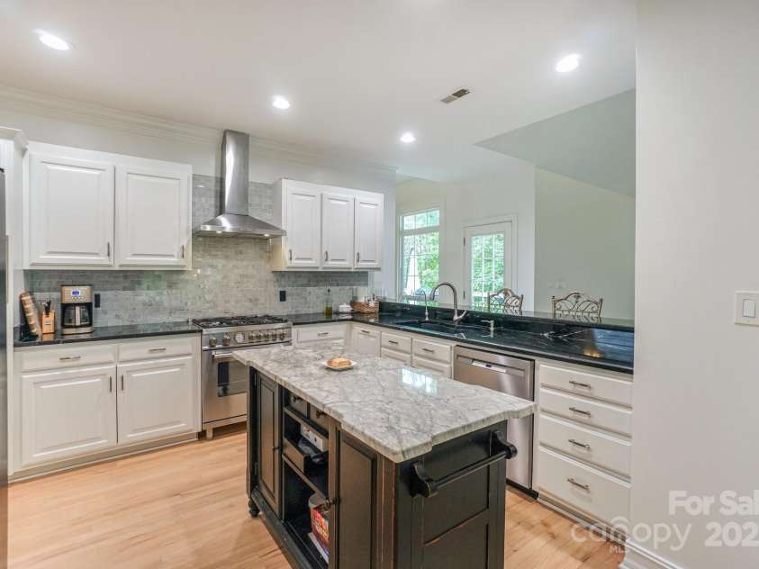 14831 Charterhouse Lane, Huntersville, NC 28078.  MLS# CAR4264707, YatesRealty ID 19794. Completely remodeled Kitchen with beautiful white cabinets, granite countertops, Free-standing Dual fuel range w/ stainless steel hood, and portable island