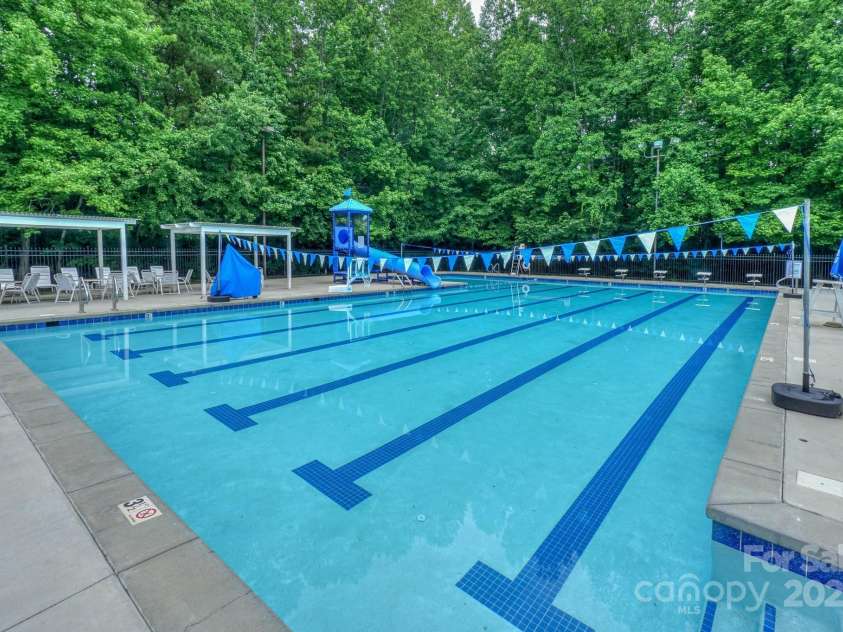14831 Charterhouse Lane, Huntersville, NC 28078.  MLS# CAR4264707, YatesRealty ID 19794. Enjoy playing in this amazing pool with slide or watch the Wynfield Waves win another season
