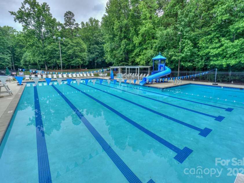 14831 Charterhouse Lane, Huntersville, NC 28078.  MLS# CAR4264707, YatesRealty ID 19794. Enjoy playing in this amazing pool with slide or watch the Wynfield Waves win another season