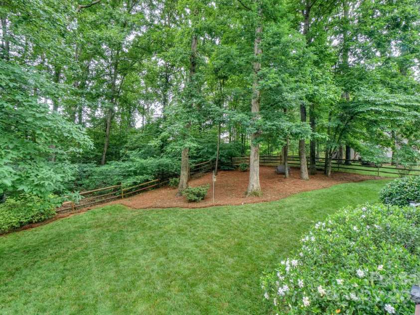 14831 Charterhouse Lane, Huntersville, NC 28078.  MLS# CAR4264707, YatesRealty ID 19794. Well manicured backyard backing up to wooded common area