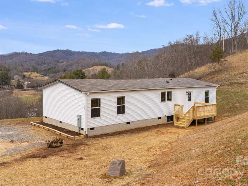 96 Sandons Trail, Marshall, NC 28753.  MLS# CAR4224480, YatesRealty ID 19813. Back of the home w/ view