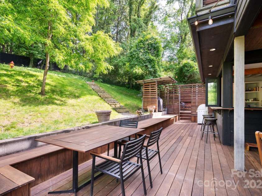 53 Buchanan Place, Asheville, NC 28801.  MLS# CAR4257148, YatesRealty ID 19830. Built-in benches for al fresco dining with covered grill area