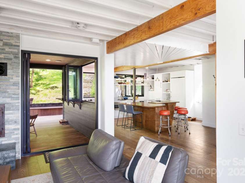 53 Buchanan Place, Asheville, NC 28801.  MLS# CAR4257148, YatesRealty ID 19830. Living area open to kitchen and outdoor covered deck with fireplace