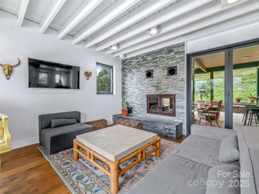 53 Buchanan Place, Asheville, NC 28801.  MLS# CAR4257148, YatesRealty ID 19830. Living area with wood burning fireplace that also opens onto back deck
