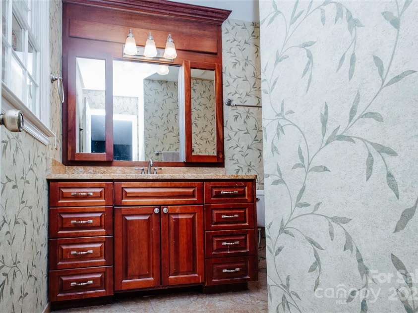 277 Forest Road, Marion, NC 28752.  MLS# CAR4252447, YatesRealty ID 19831. Attractive vanity with mirror off of primary bedroom