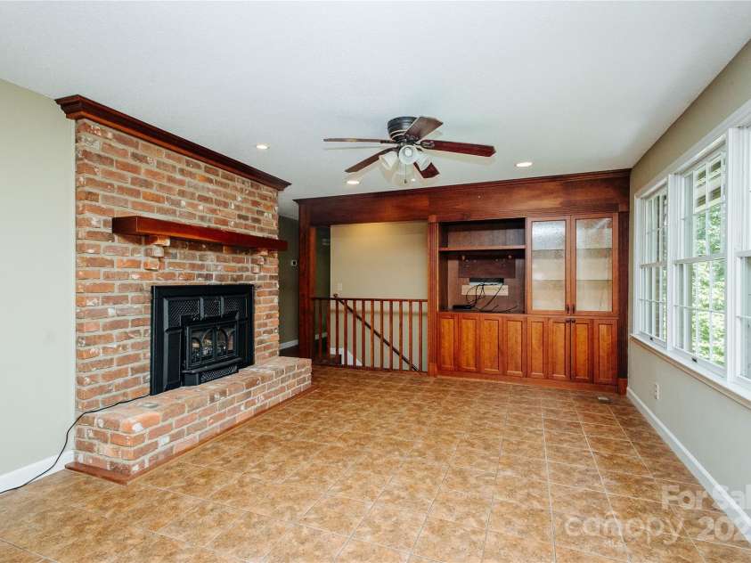 277 Forest Road, Marion, NC 28752.  MLS# CAR4252447, YatesRealty ID 19831. Den has an attractive propane gas FP and cabinets for TV and other treasures.