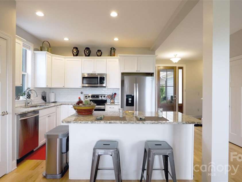 50 Rose Creek Road, Leicester, NC 28748.  MLS# CAR4228303, YatesRealty ID 19833. Kitchen Island makes a great place for eating and conversation