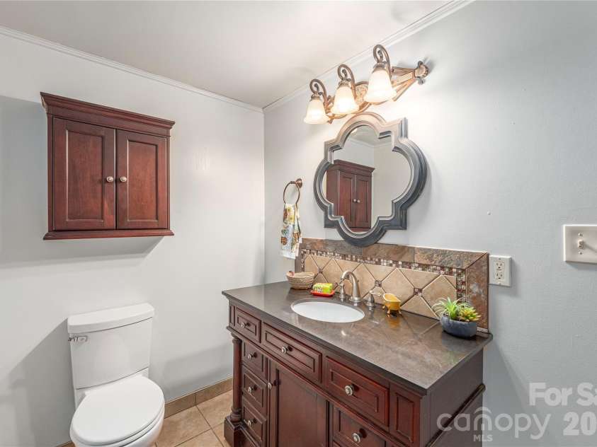 35 Grey Rock Valley, Black Mountain, NC 28711.  MLS# CAR4359846, YatesRealty ID 19842. Large bathroom has custom vanity with granite top