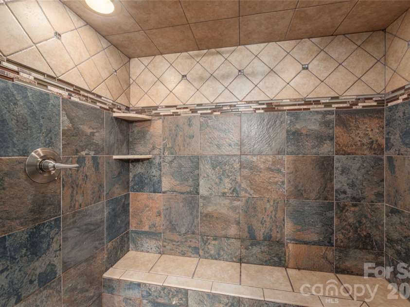 35 Grey Rock Valley, Black Mountain, NC 28711.  MLS# CAR4359846, YatesRealty ID 19842. Large walk-in shower with bench.